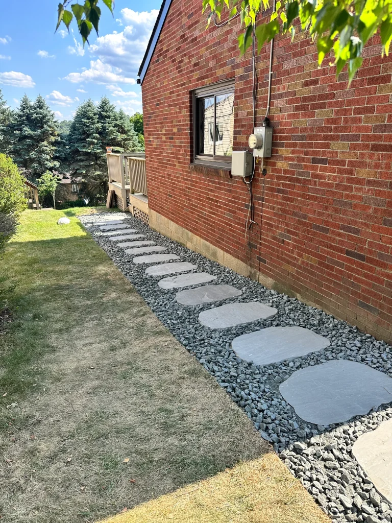 Rock Bed With Stepping Stone Pathway Alongside House