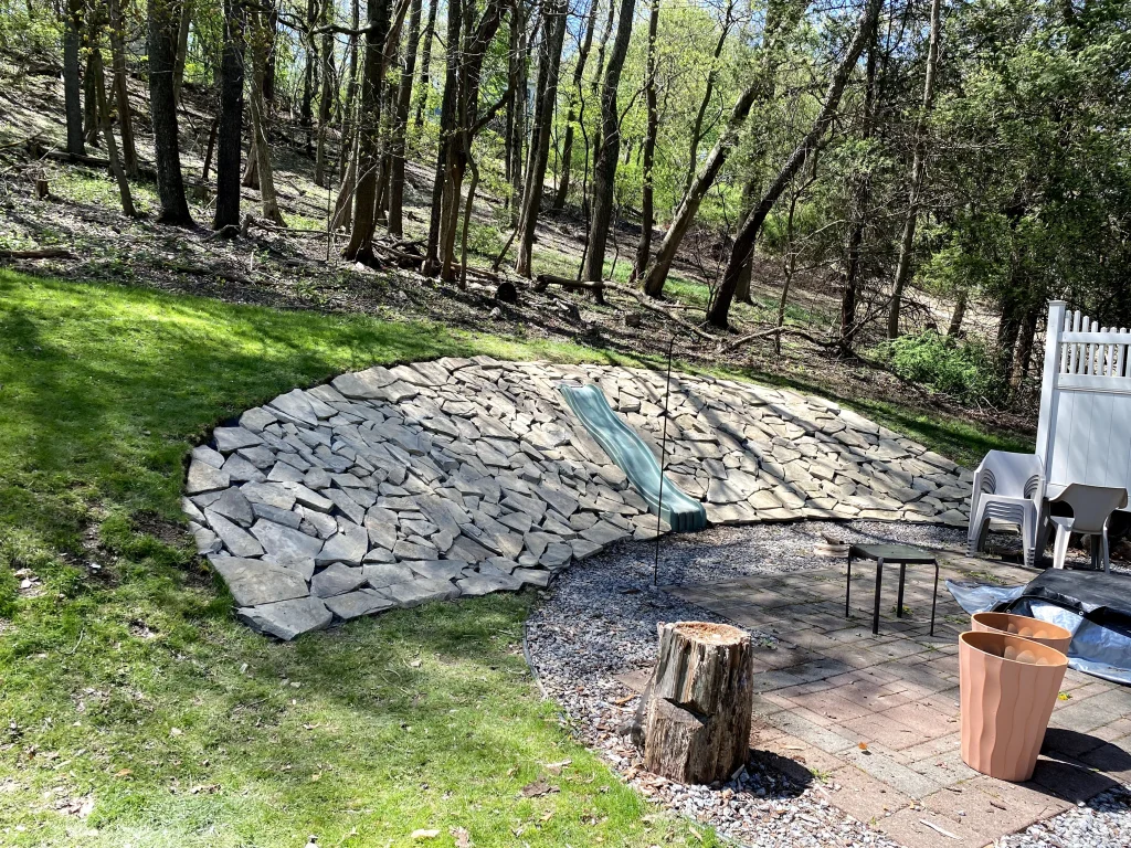 Large Flat Rock Installation Surrounding Backyard Slide