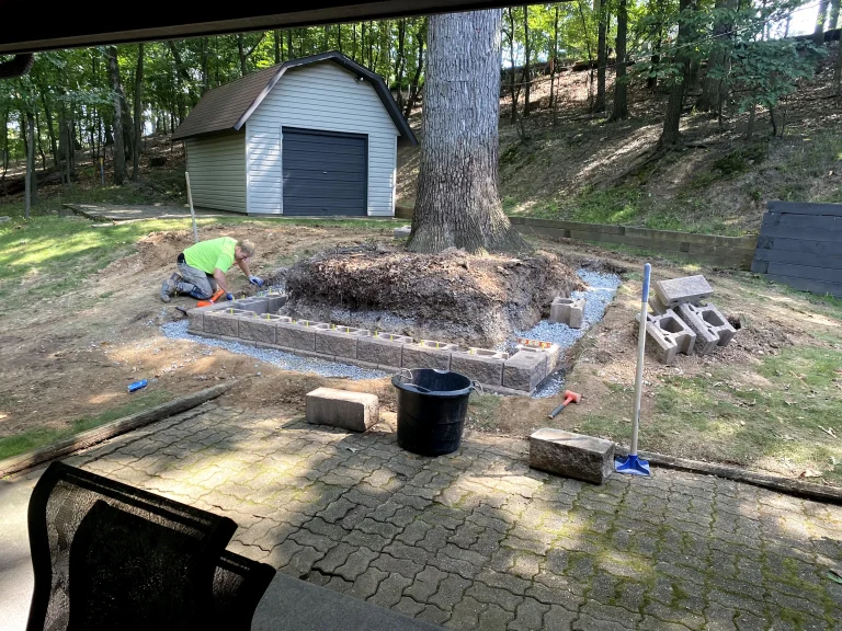 Retaining Wall Blocks Being Laid Around A Tree Base