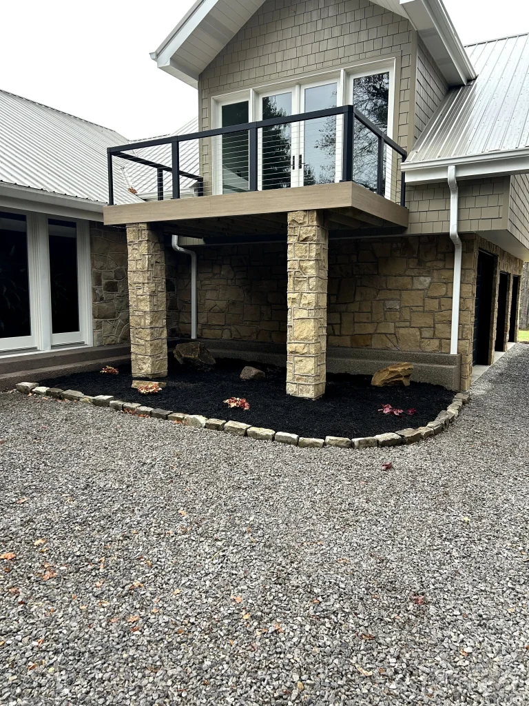 Cobble Stone Bordered Mulch Bed Underneath Balcony