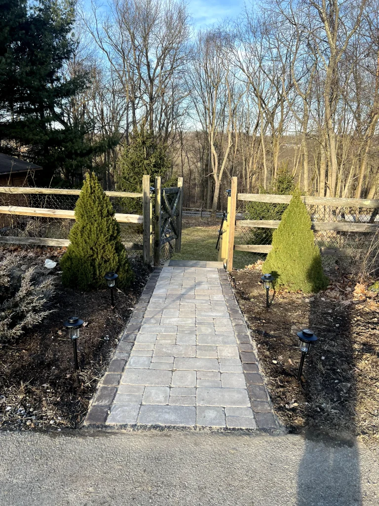 Paver Pathway To Wooden Fence